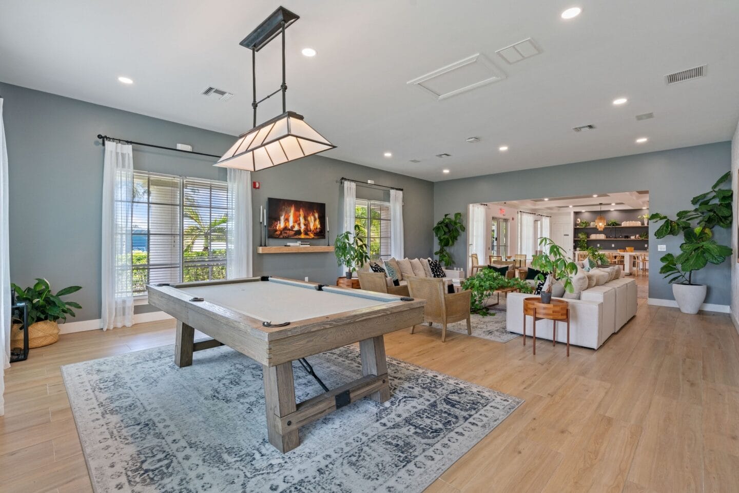 a game room with a pool table and a fireplace