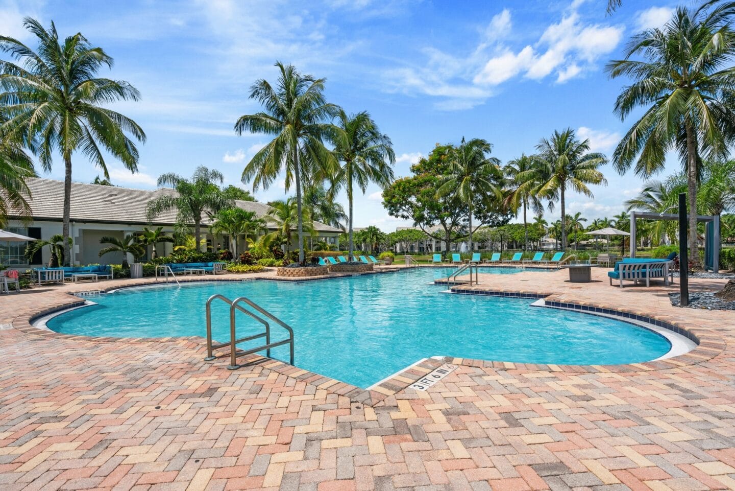 a swimming pool at a resort with palm trees