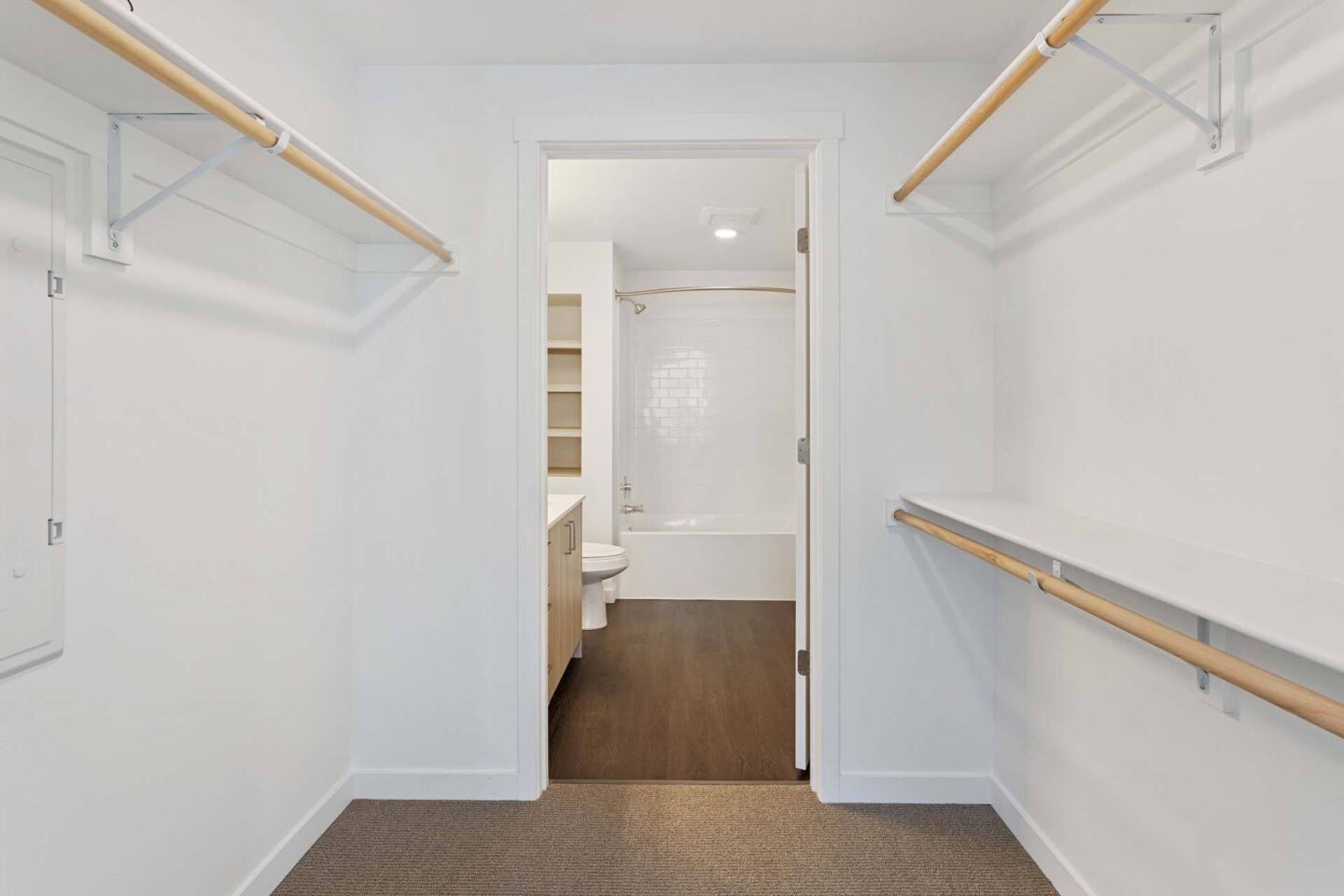 A hallway with white walls and a brown carpet at Windsor Totem Lake, 11723 NE 117th Ct, Kirkland, WA 98034.