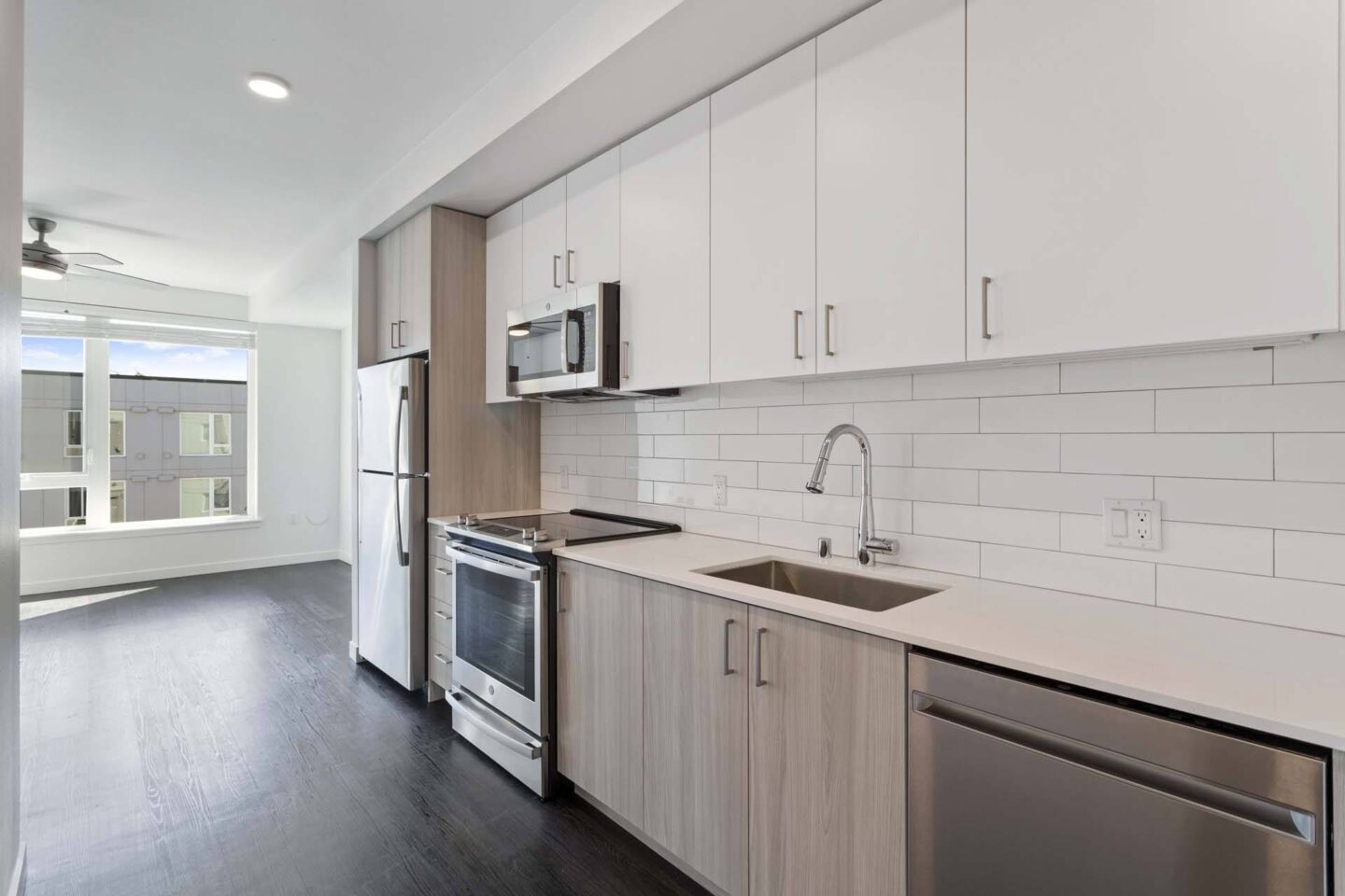 A modern kitchen with white cabinets and stainless steel appliances at Windsor Totem Lake, 11723 NE 117th Ct, Kirkland, WA 98034.