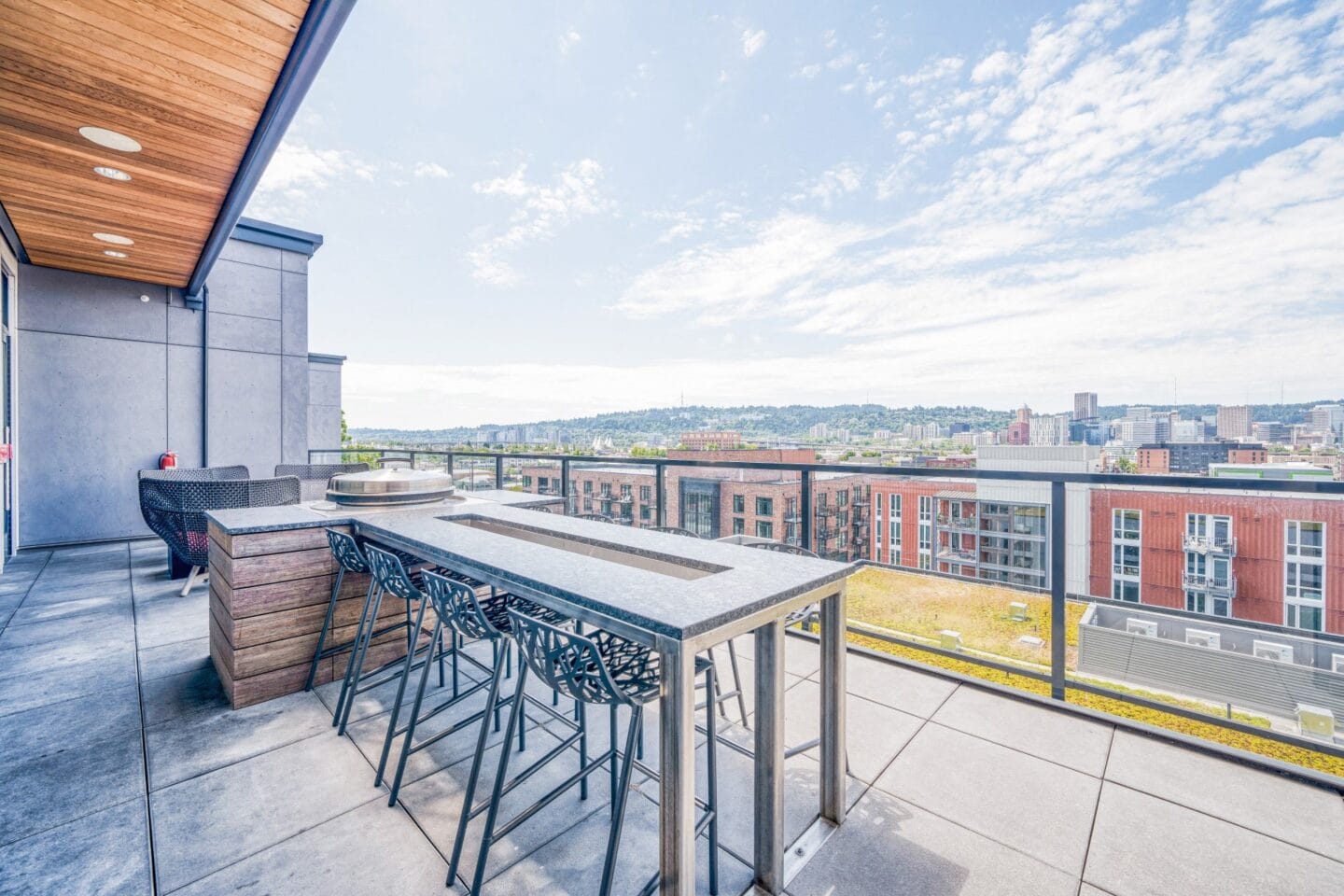 a bar area on the roof of a building with a view of the city