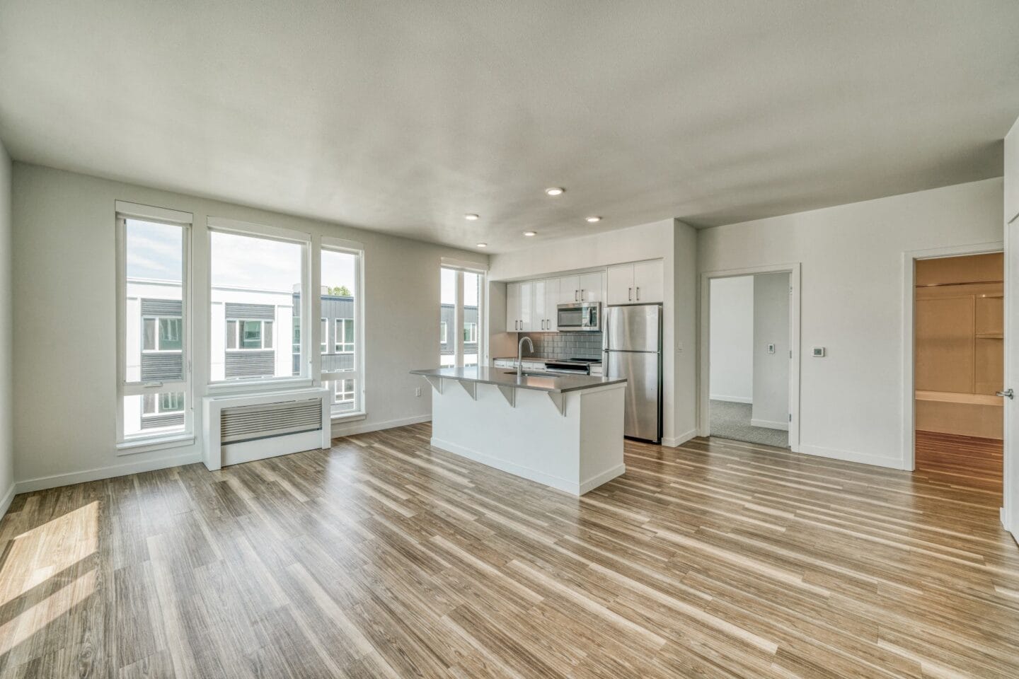 Kitchen and living room with hardwood floors and a large window  at Windsor Buckman, Portland, Oregon