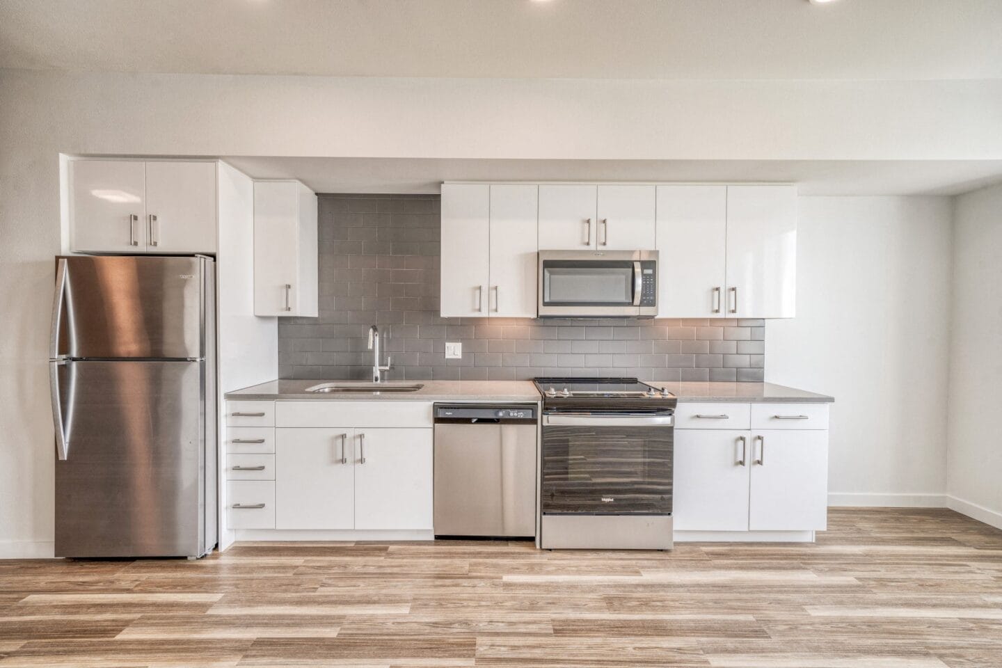 Kitchen with white cabinets and stainless steel appliances  at Windsor Buckman, Portland, Oregon