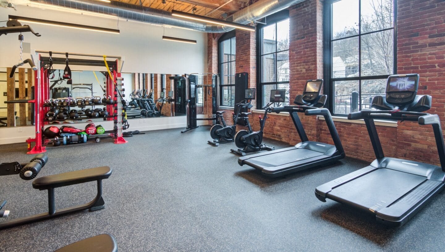 Gym with cardio equipment and weights at Windsor Radio Factory, Melrose, MA