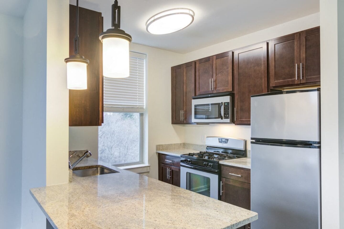 Kitchen with a large island and stainless steel appliances at Windsor Radio Factory, Melrose, MA