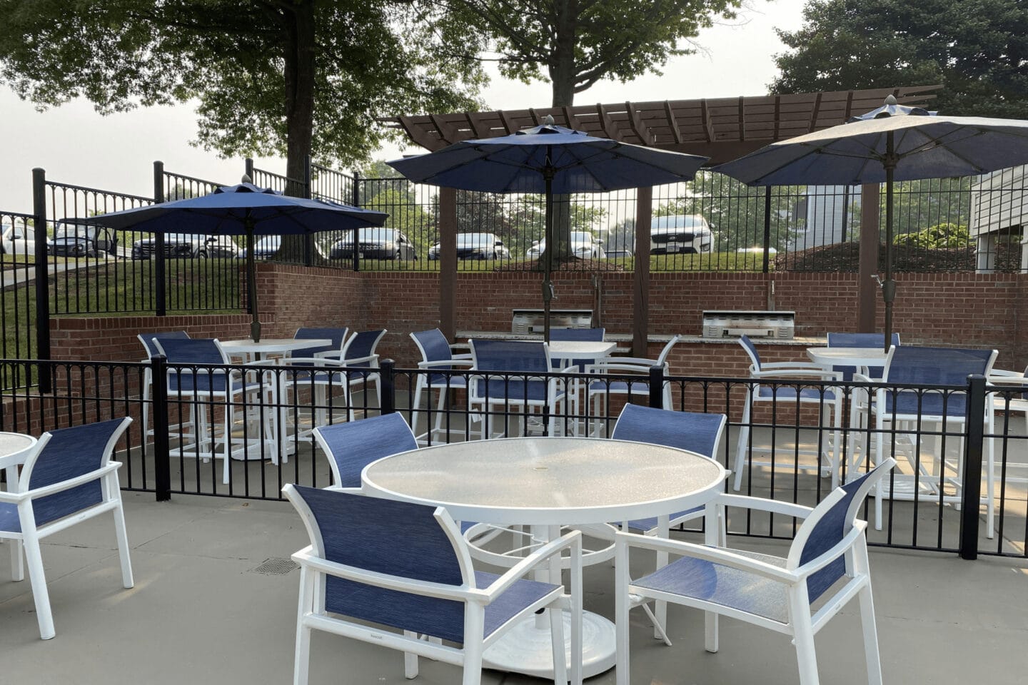 an outdoor patio with tables and chairs and umbrellas