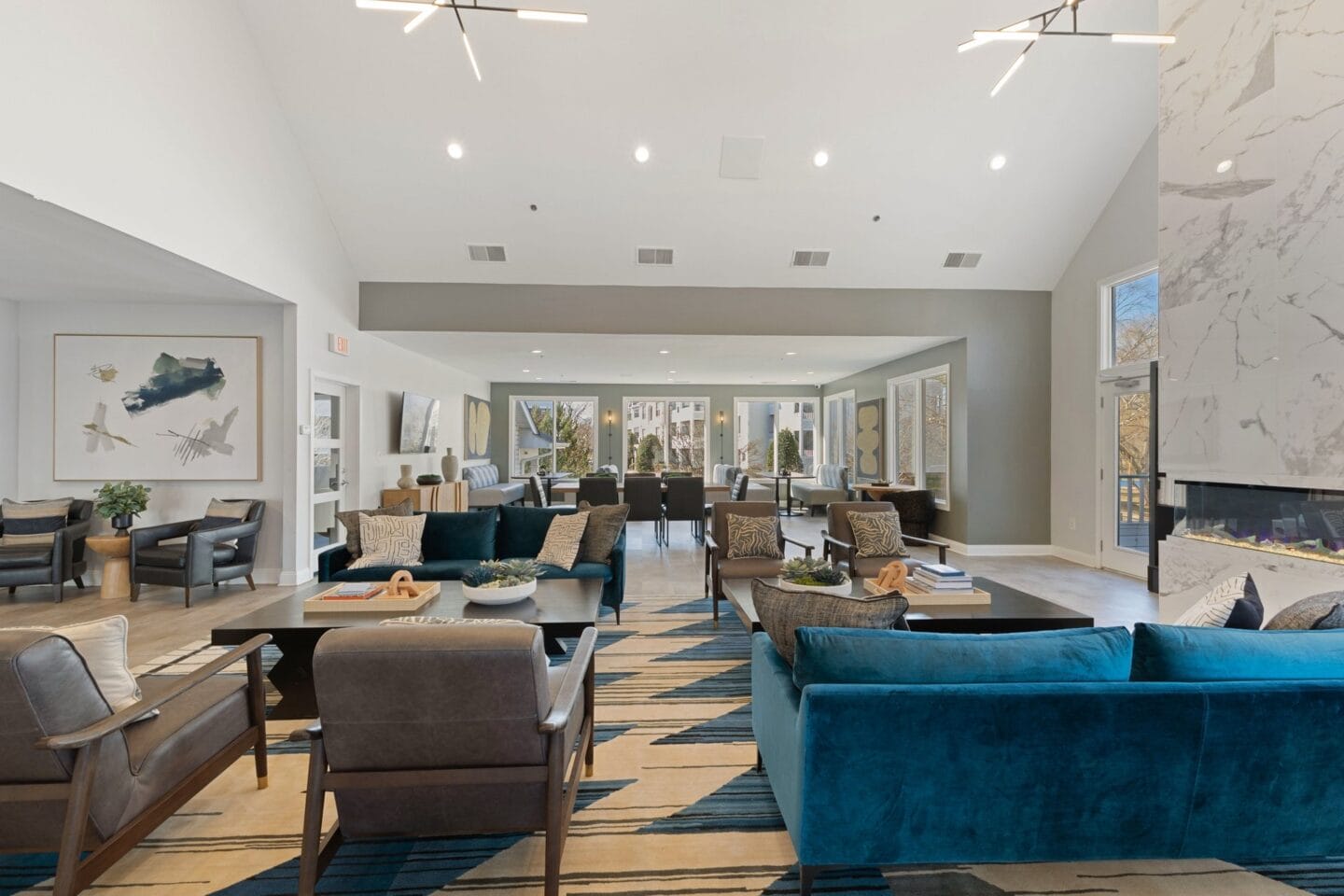 a living room with blue couches and chairs and a fireplace