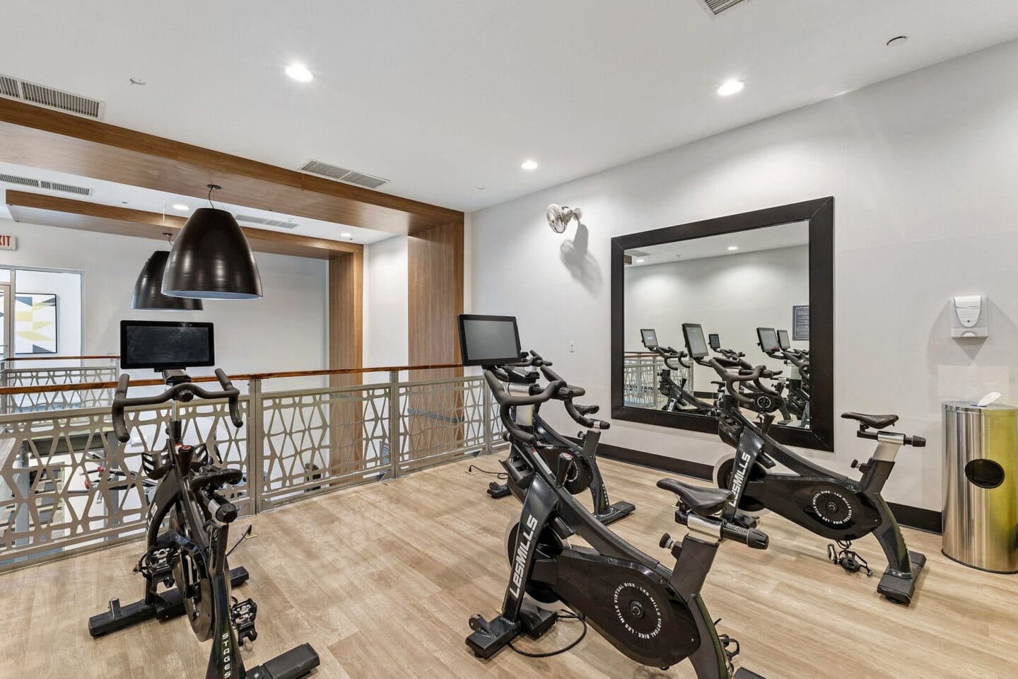 a gym with exercise machines and a mirror on the wall