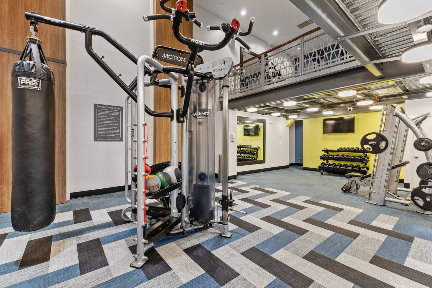 a home gym with weights and a punching bag on the floor