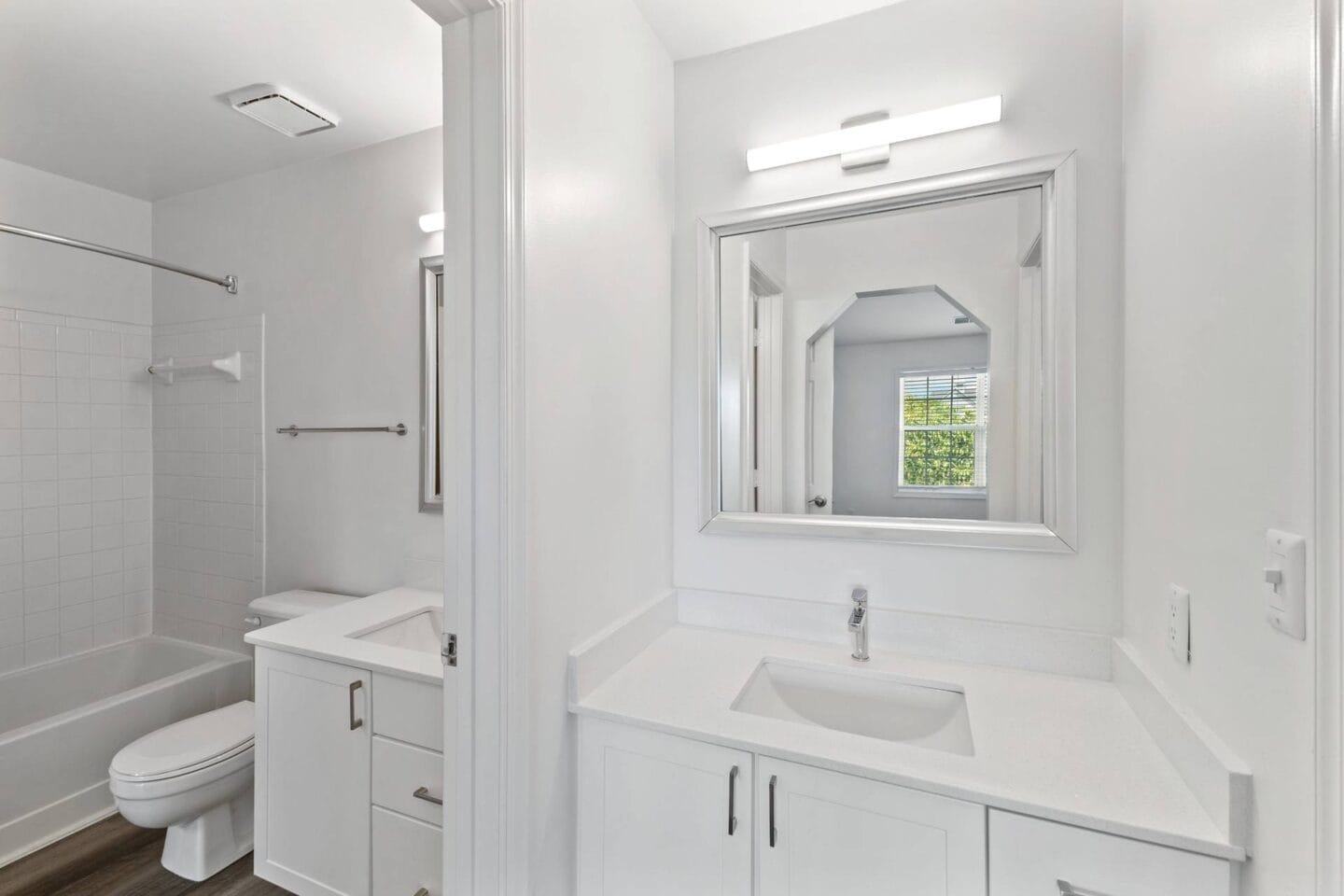 a white bathroom with a sink and a mirror