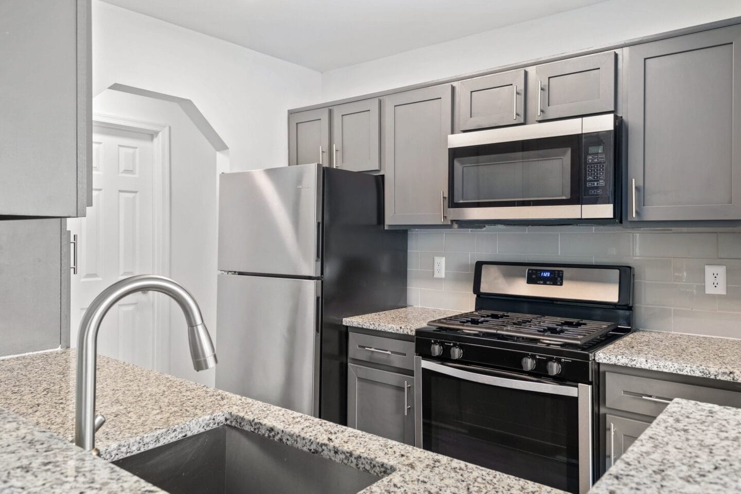 a kitchen with granite counter tops and stainless steel appliances