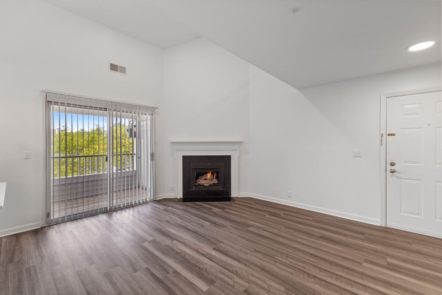 a living room with a fireplace and a sliding glass door