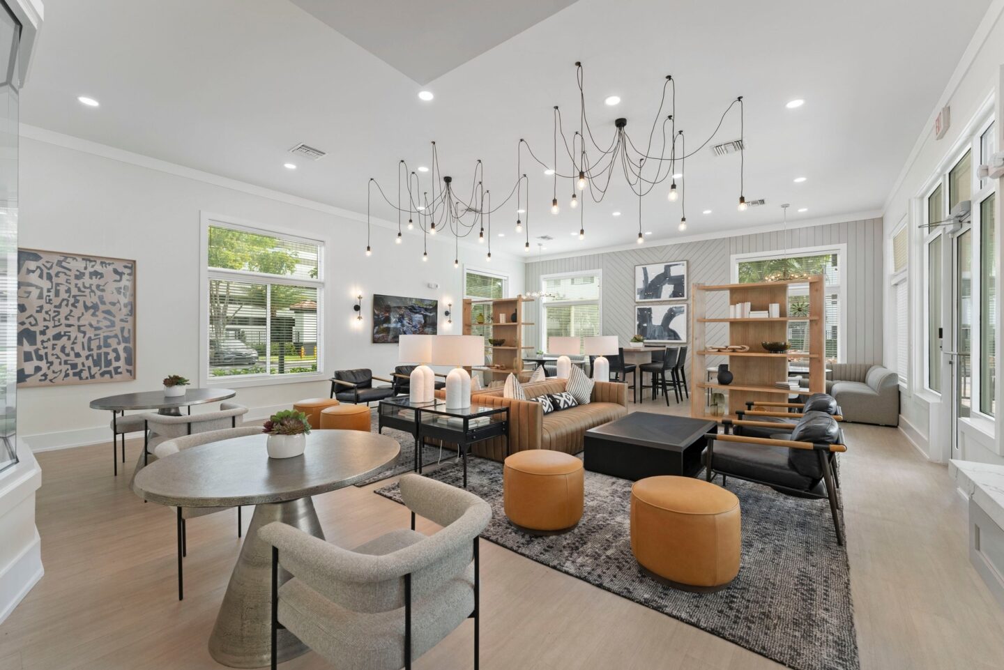 a living room with couches chairs and tables and a chandelier