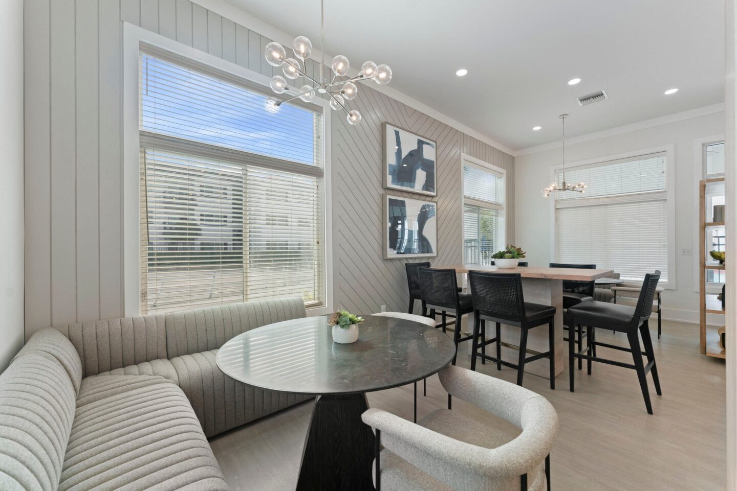 a living room with a couch and a table with chairs