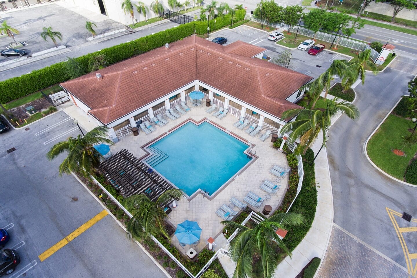 Aerial view of the the community pool and apartment building at Windsor Biscayne shores in North Miami