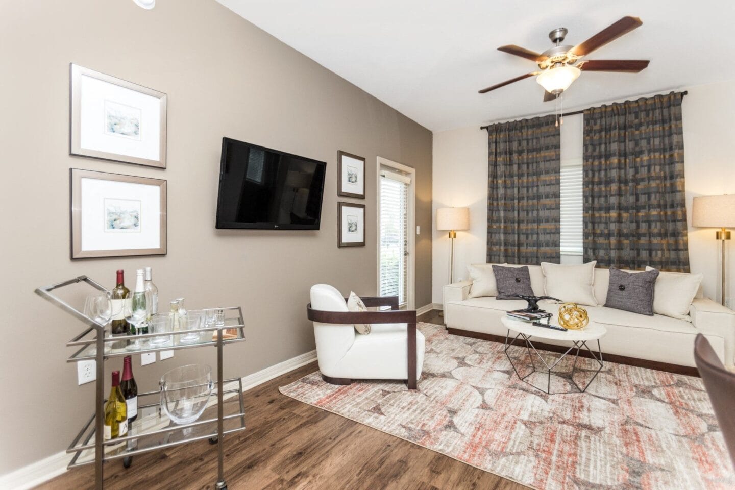 Modern living room with ceiling fan and a tv available at Windsor Biscayne Shores  in North Miami