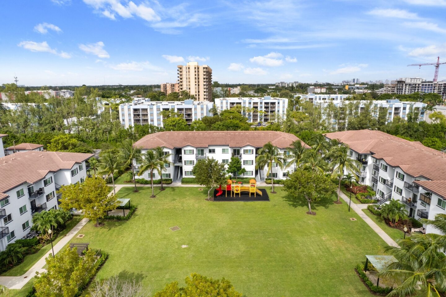 a mansion with a large lawn and a picnic area in the middle