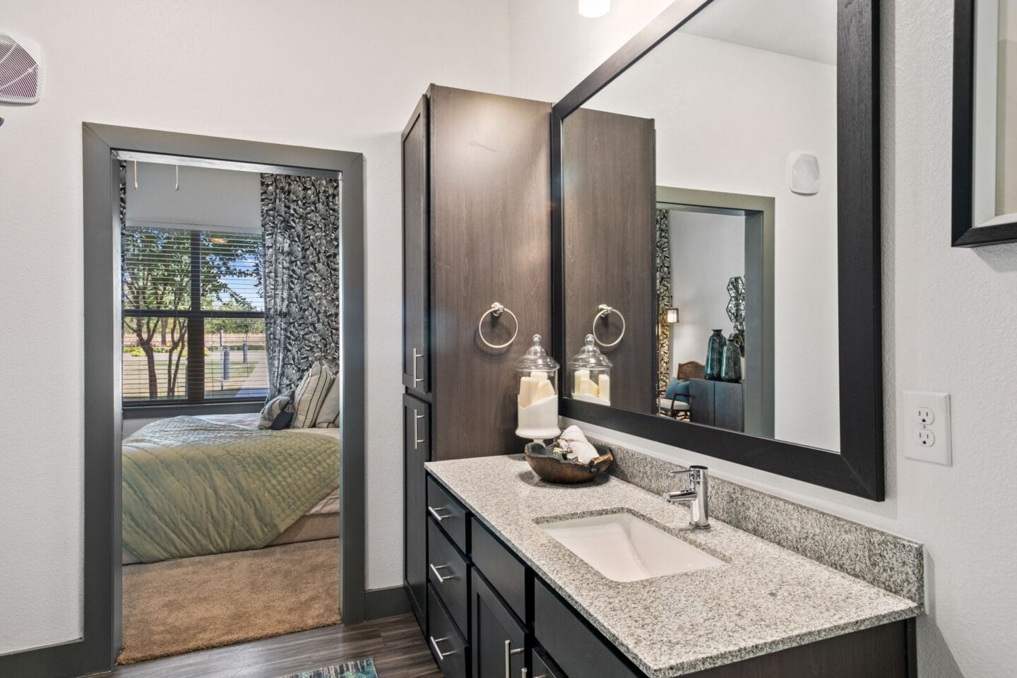 Primary bathroom with cabinets at The Lakeyard District