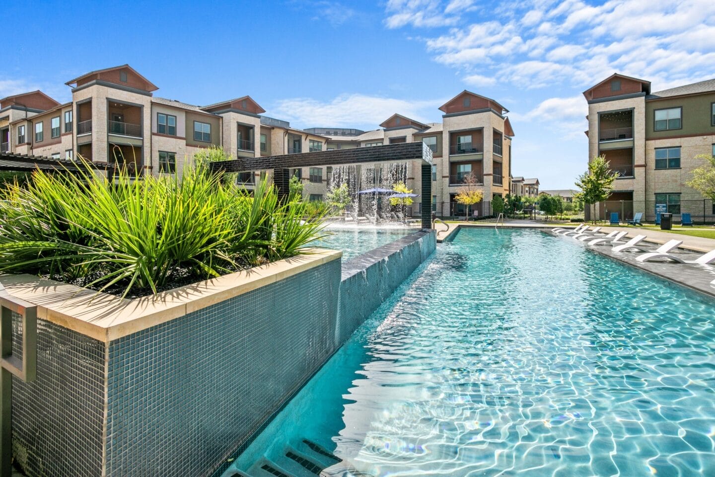 Swimming pool with apartment buildings in the background at The Lakeyard District