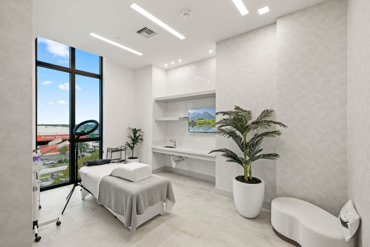 Spa room with a massage table and a large potted plant at Windsor Ludlam Trail in Miami, FL.