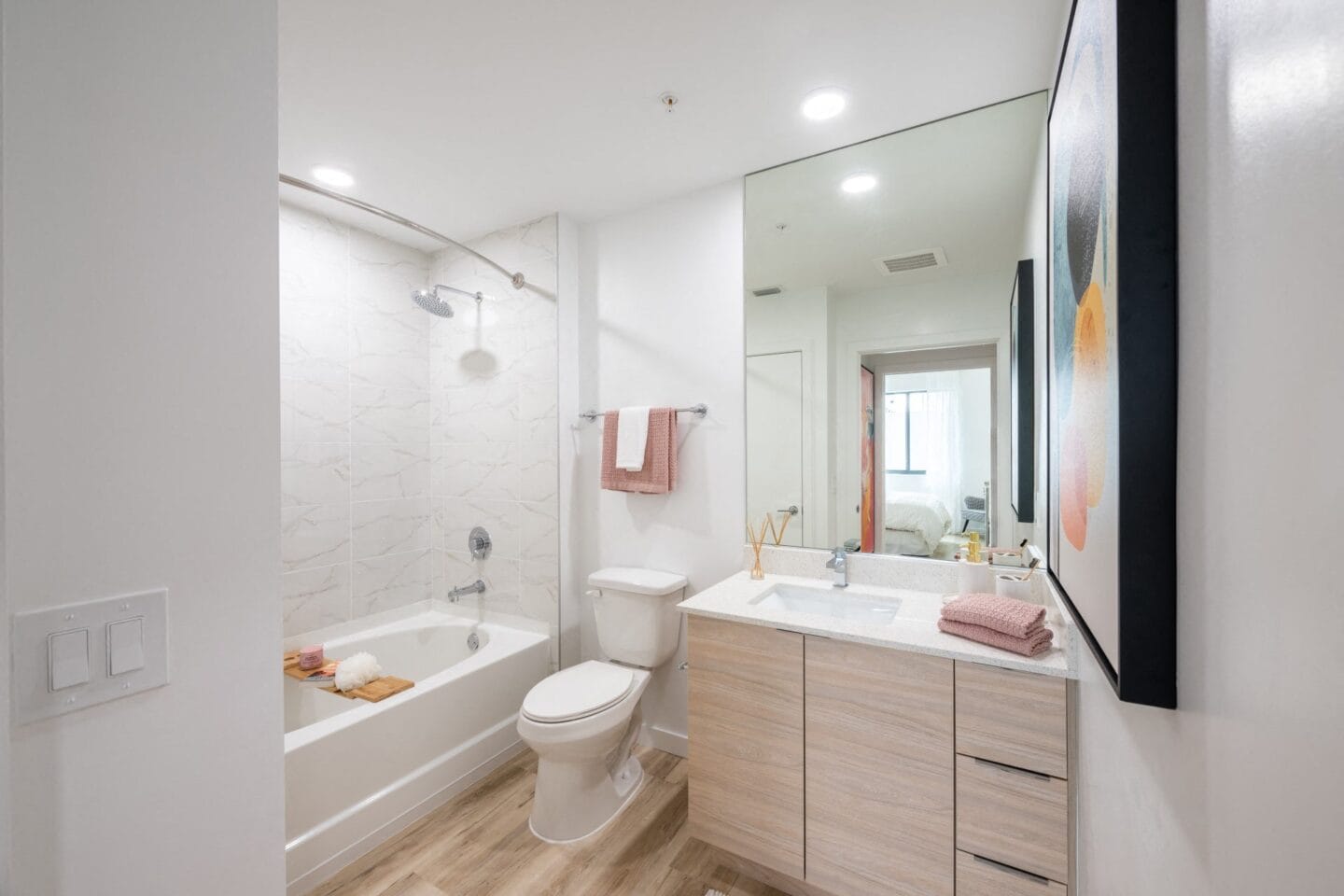 Bathroom with white walls and wood flooring at Windsor Ludlam Trail in Miami, FL.