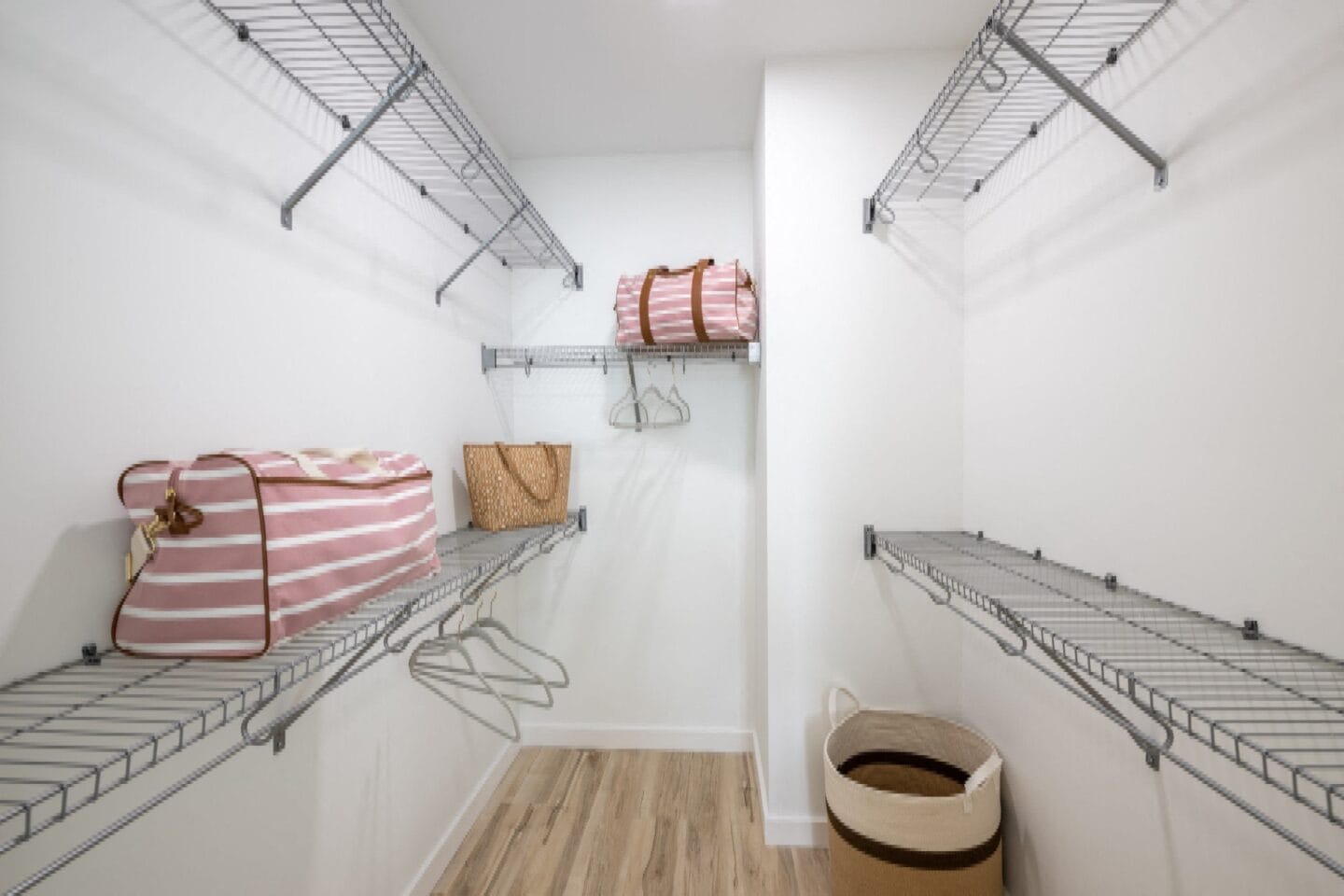 Sspacious walk in closet with metal shelves and baskets at Windsor Ludlam Trail in Miami, FL.