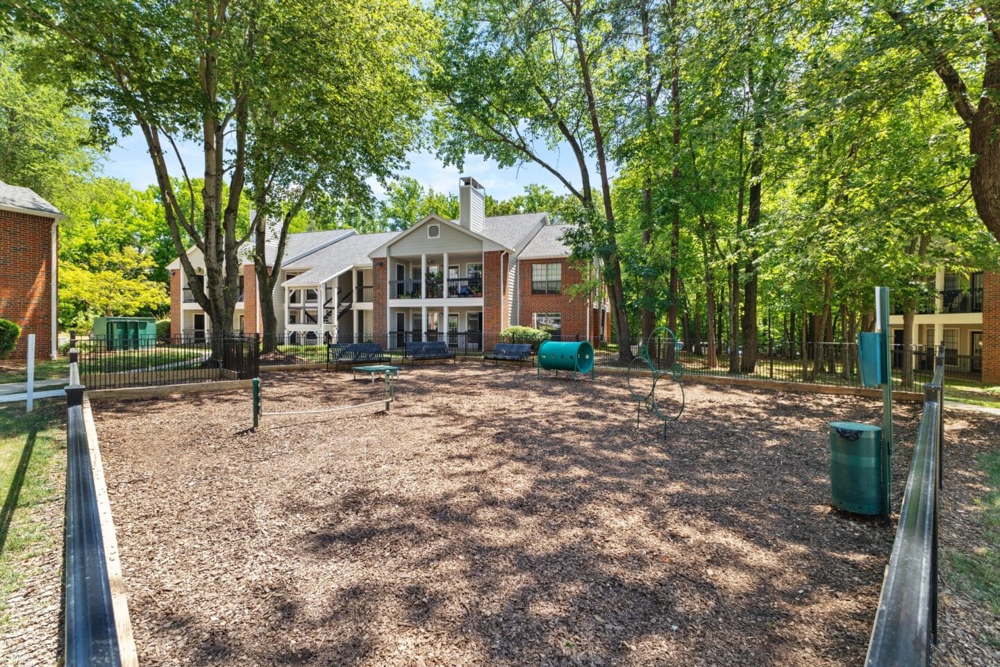 a dog park with a house in the background