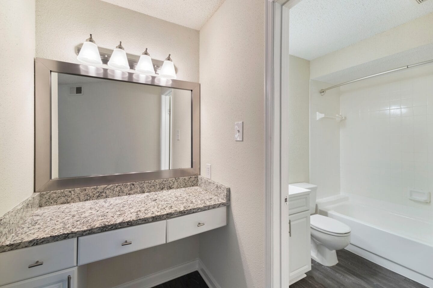 the preserve at ballantyne commons apartment bathroom with sink and mirror and toilet