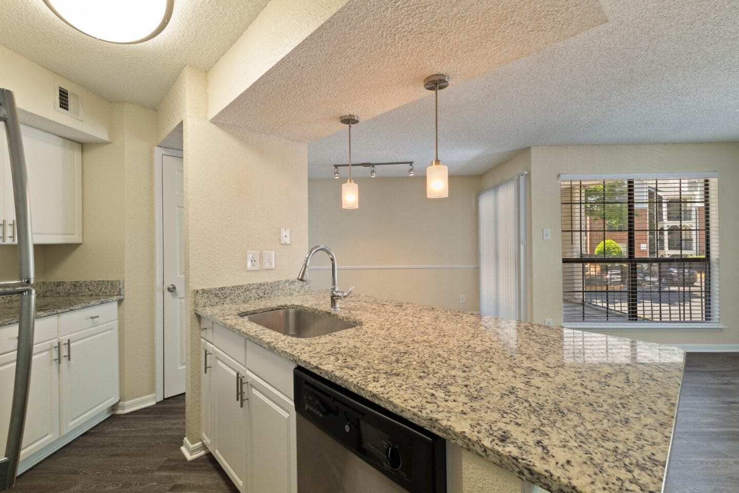 a kitchen with a granite counter top and a sink