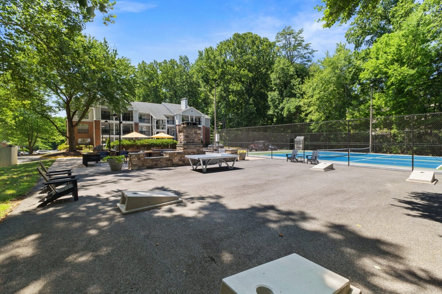 a large yard with a pool and picnic tables