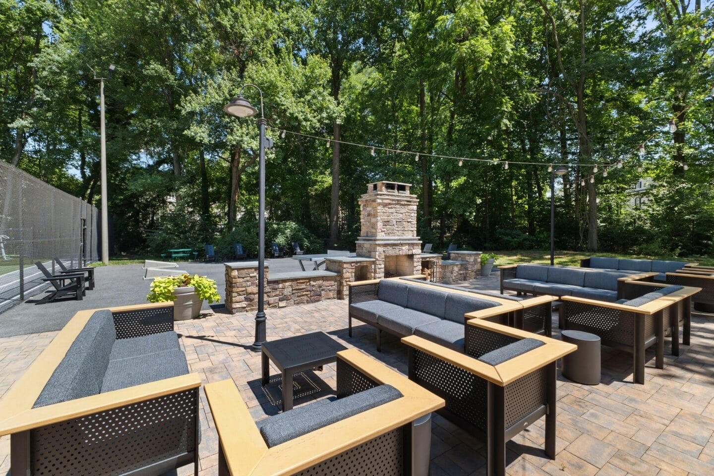 a patio with tables and chairs and a fire pit