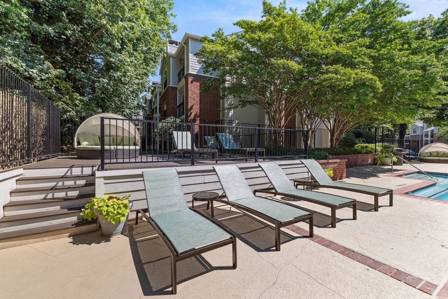 our apartments have a large patio with lounge chairs and a pool