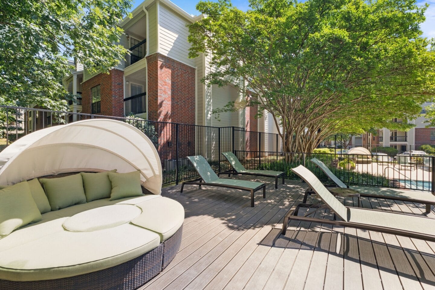 a patio with a couch and a table and chairs