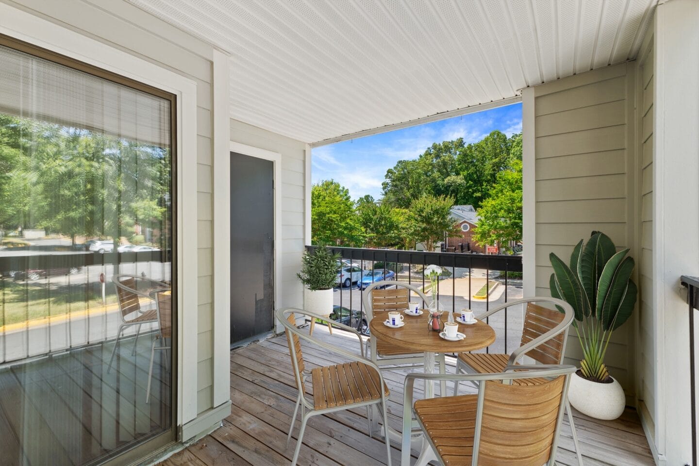 a patio with a table and chairs on a balcony