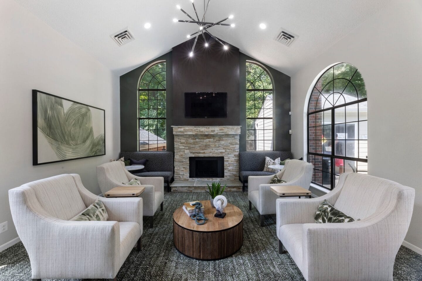 a living room with couches and chairs and a fireplace