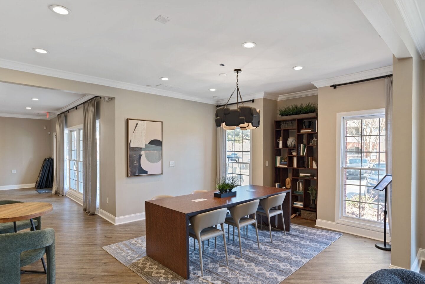 a dining room with a wooden table and chairs