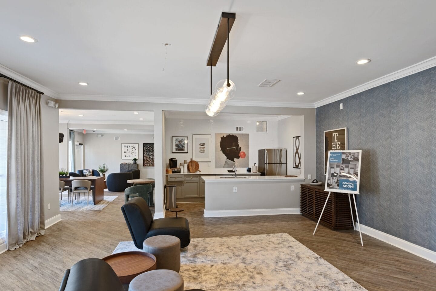 a living room with a kitchen and a table and chairs