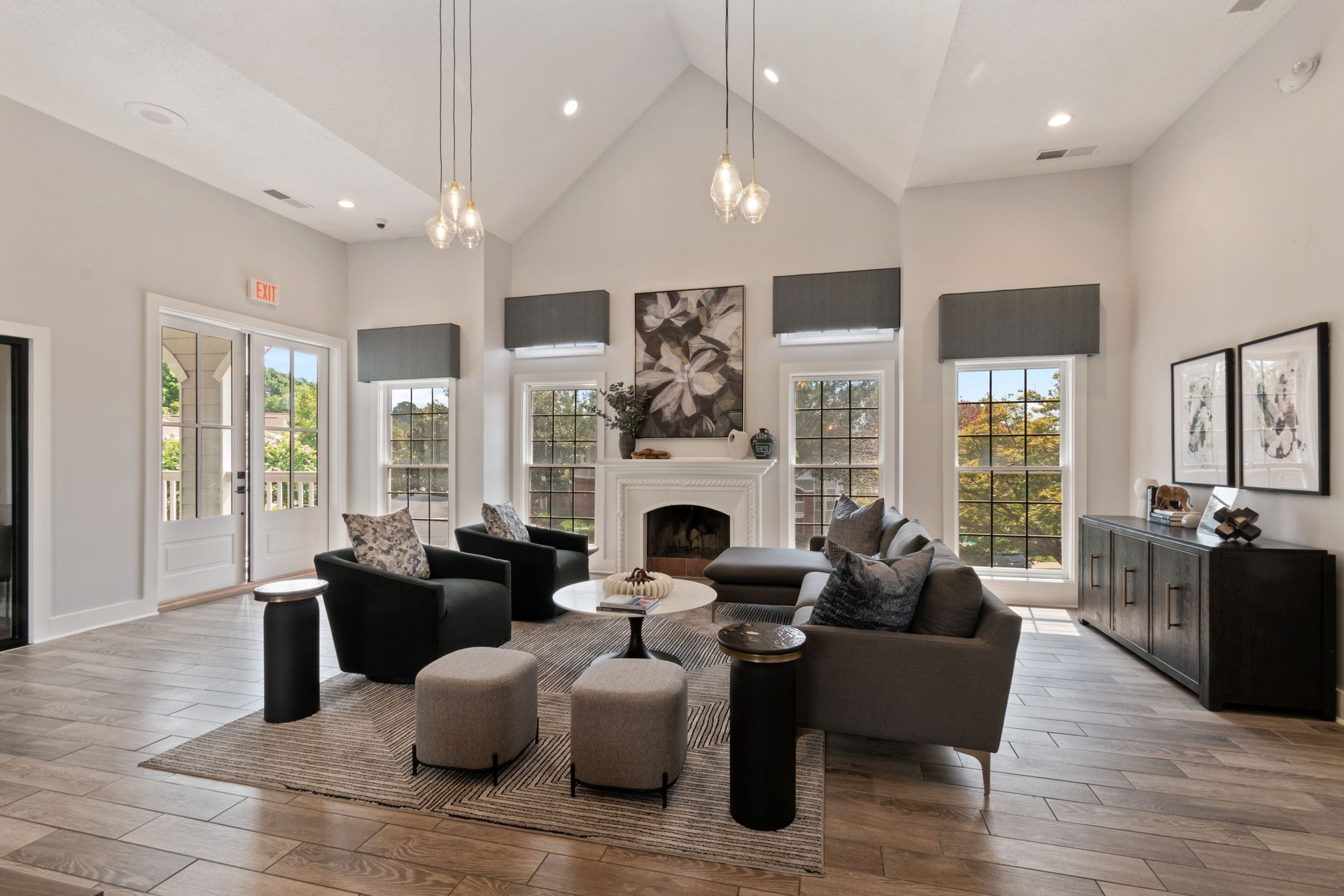 A living room with a fireplace and a large painting above it.