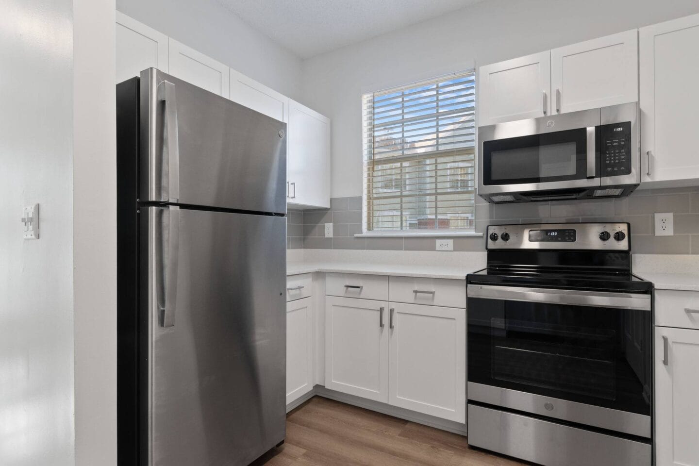 Kitchen with stainless steel appliances and white cabinets at Windsor Vinings, Atlanta, GA