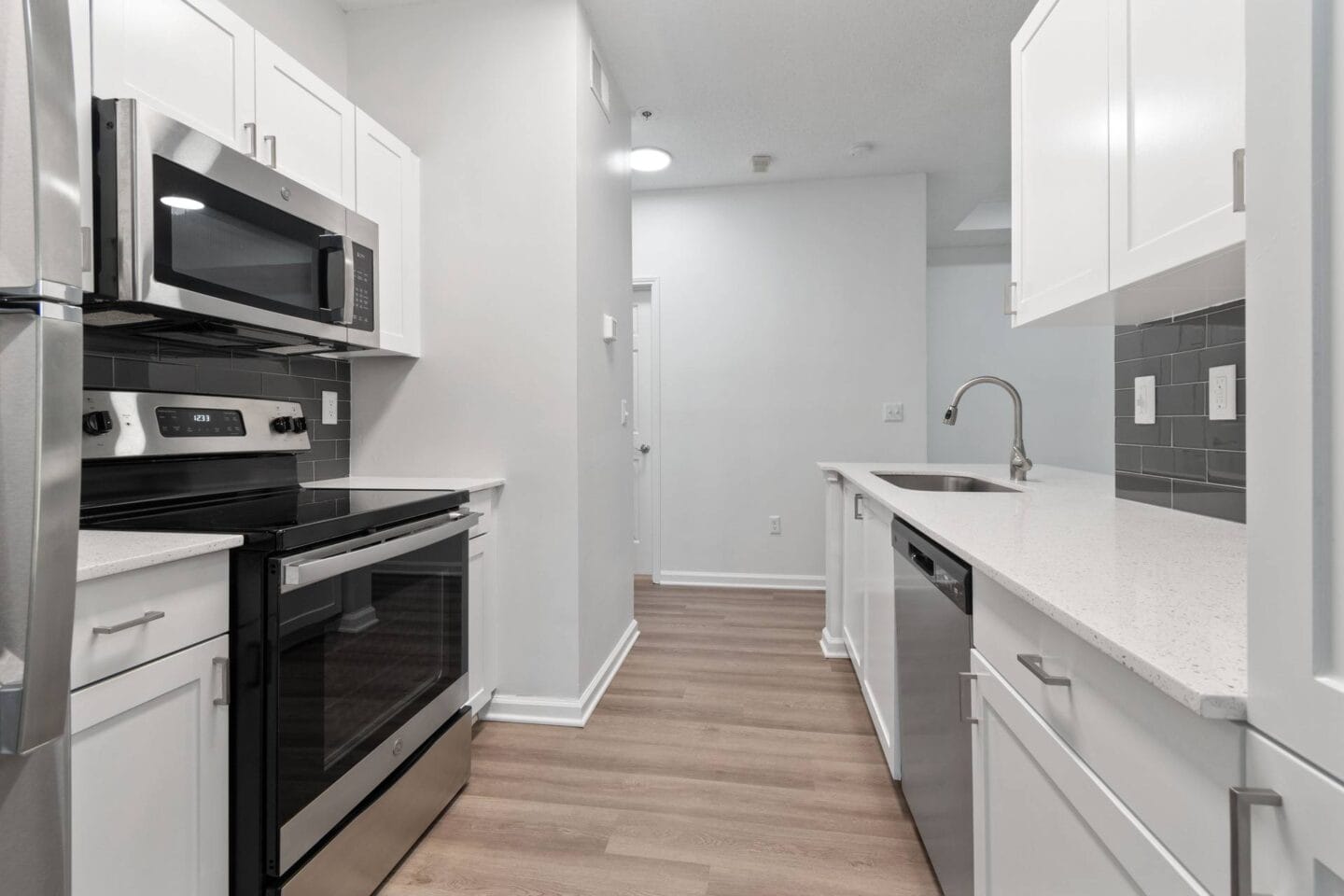 Renovated kitchen with white cabinets and black appliances at Windsor Vinings, Atlanta, GA