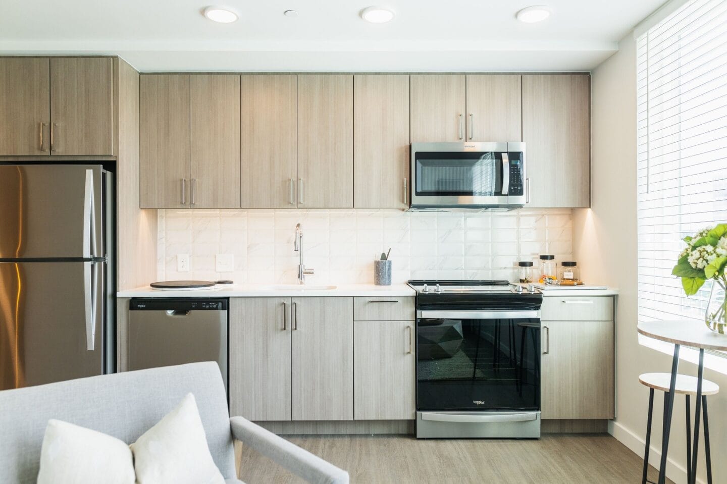 a modern kitchen with white cabinets and stainless steel appliances