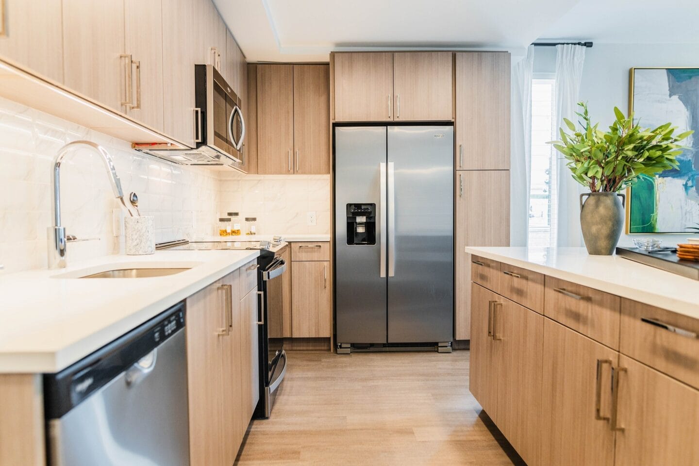 a kitchen with wooden cabinets and a stainless steel refrigerator