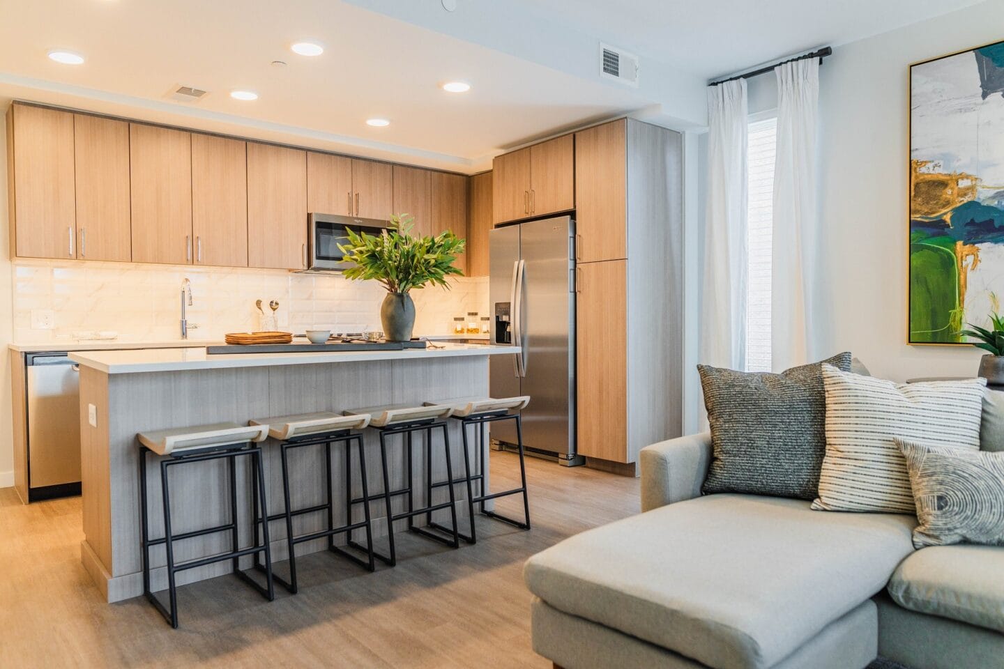 a kitchen with a bar and a living room with a couch