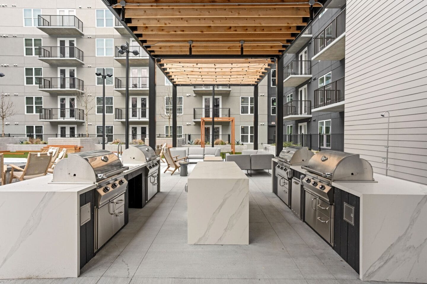 an outdoor kitchen with stainless steel appliances and a wooden roof