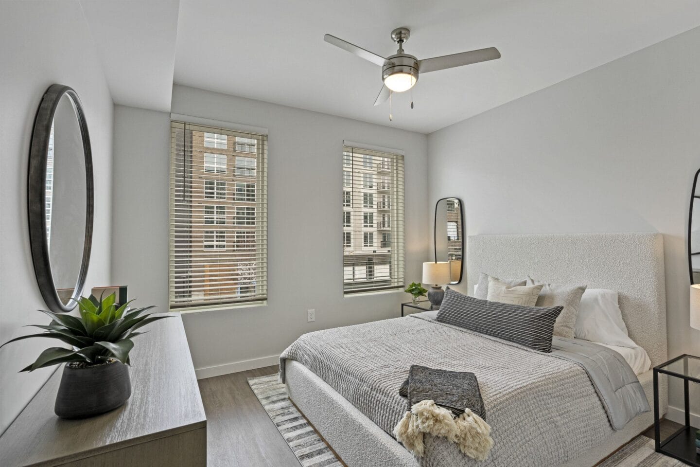 a bedroom with a large bed and a ceiling fan