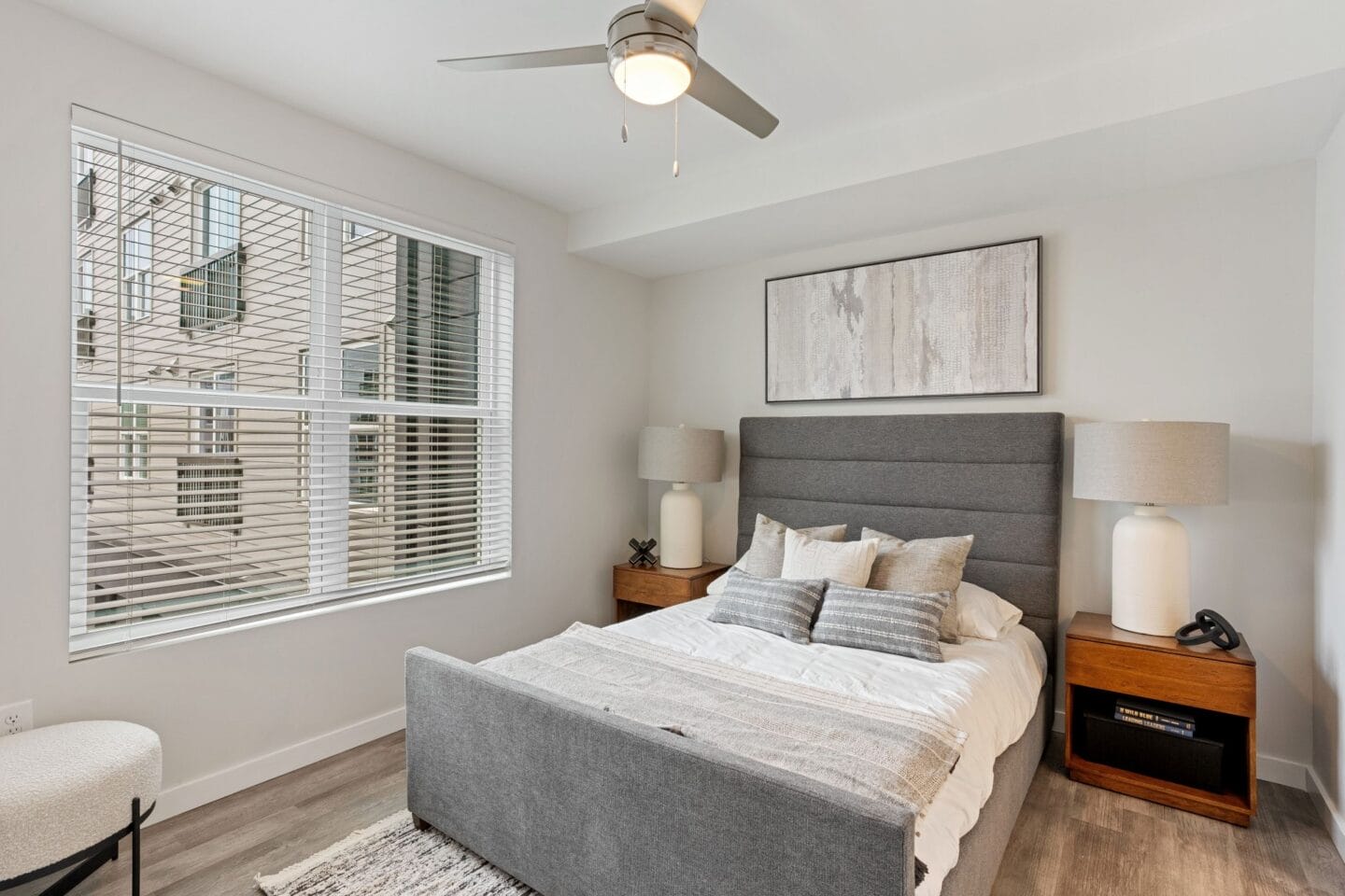 a bedroom with a bed and a ceiling fan