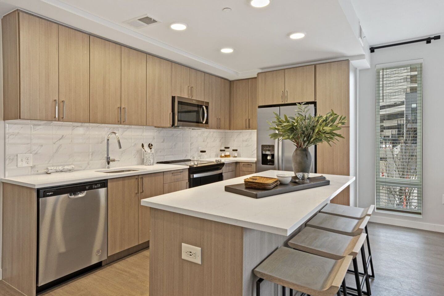 a kitchen with a large island with stools