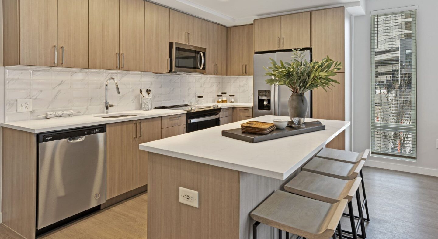 a kitchen with a large island with stools