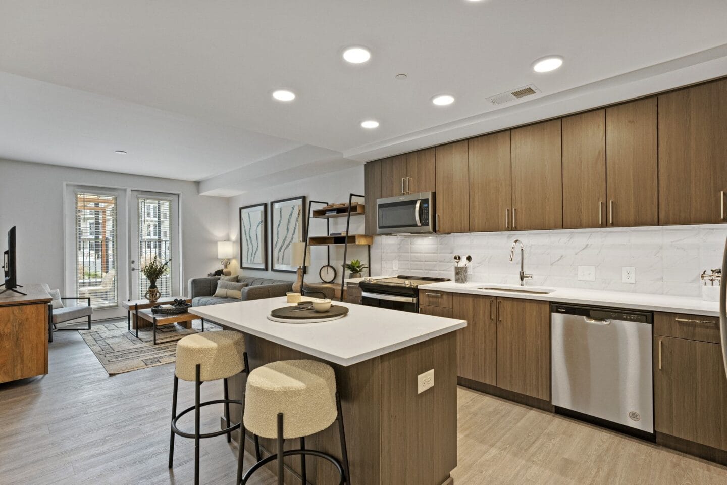 a kitchen and living room with a white counter top