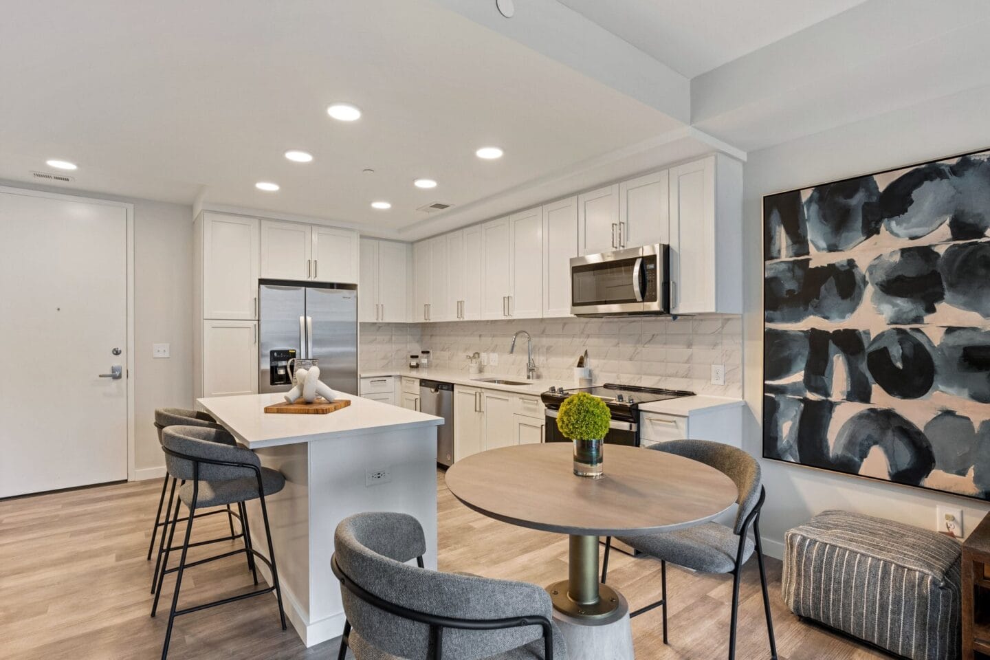 a living room with a kitchen and a table and chairs